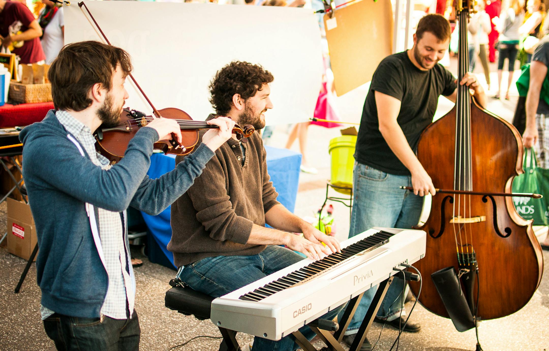 credit: Nik Rowell Photography Orange Mighty Trio performing outdoors at the Mill City Farmers Market in 2012.