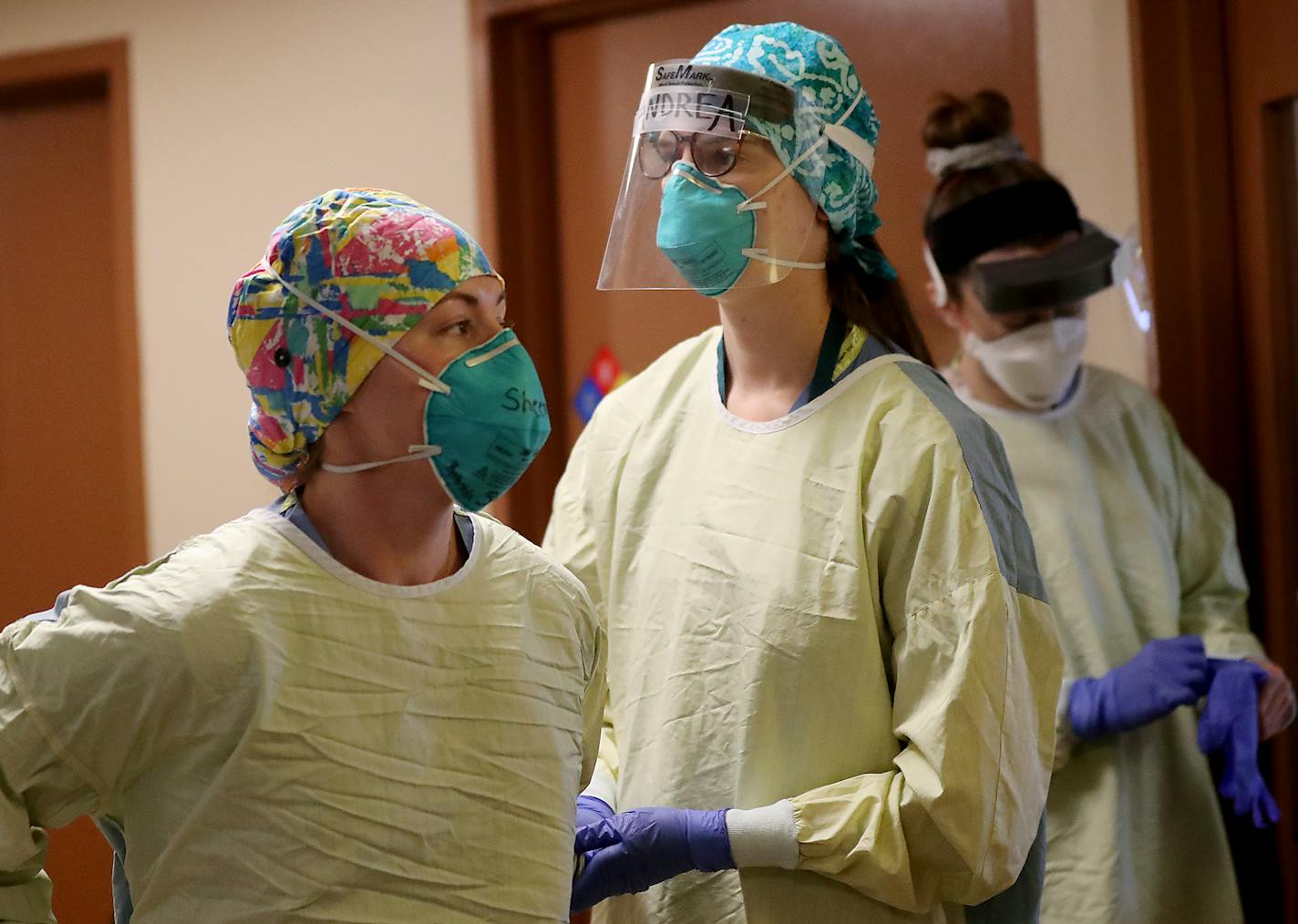 Bethesda health care workers donned PPE before rotating a COVID-19 patient on the fifth-floor ICU at the St. Paul hospital.