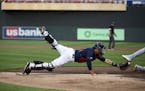 Minnesota Twins catcher Jason Castro (15) was unable to get the tag on Kansas City Royals first baseman Ryan McBroom (9) as he scored off a sacrifice 