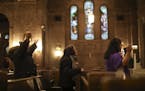 Worshipers prayed during the Thursday night mass in Spanish at Church of the Incarnation in Minneapolis. A church member was arrested in the recent sw