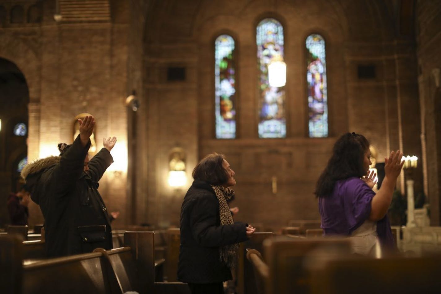 Worshipers prayed during the Thursday night mass in Spanish at Church of the Incarnation in Minneapolis. A church member was arrested in the recent sweep as he dropped off his son with a caregiver.