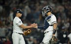 New York Yankees starting pitcher Jonathan Loaisiga and catcher New York Yankees catcher Gary Sanchez congratulated each other after the Yankees defea