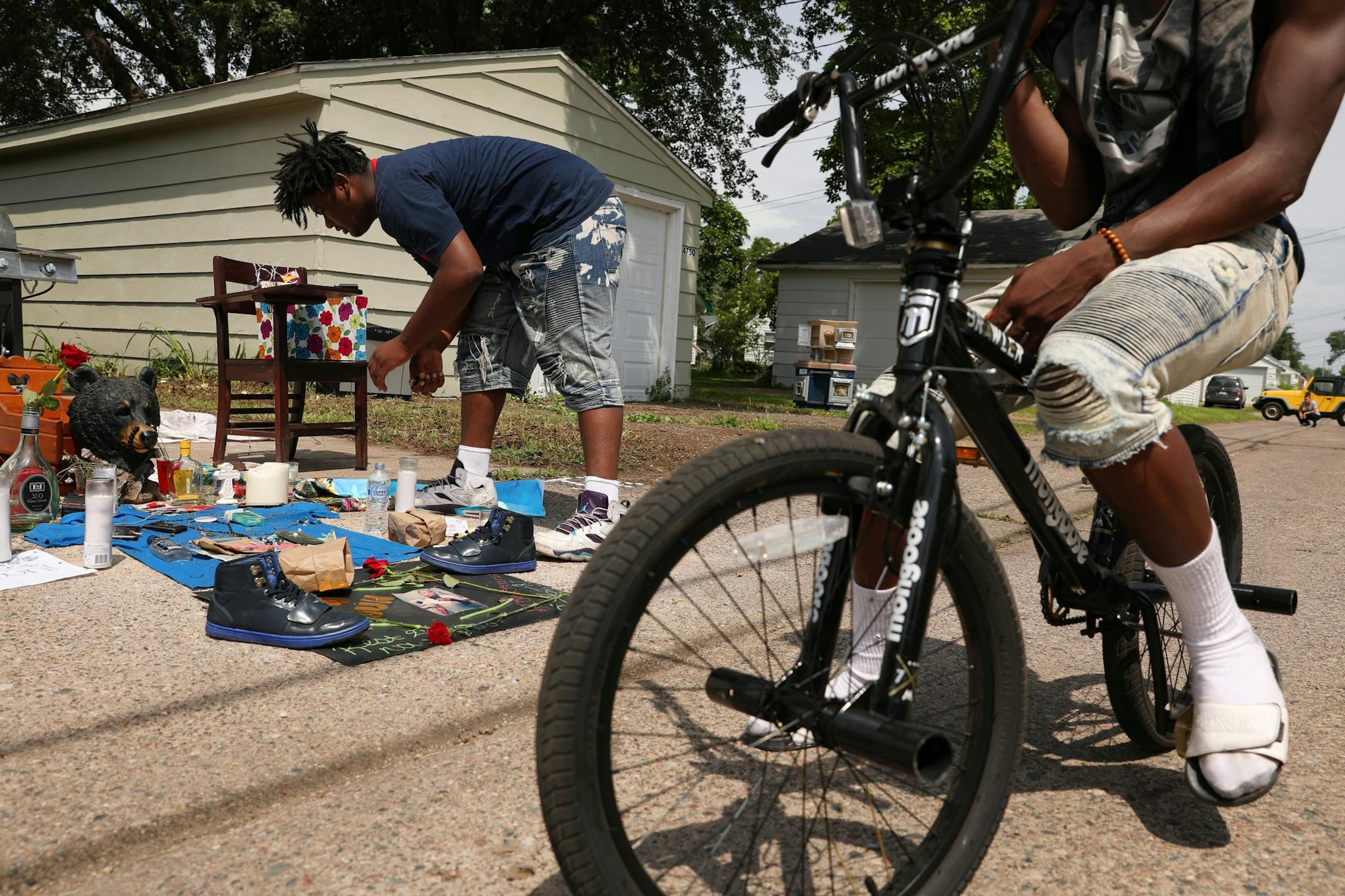 Nahaj Myles, 15, tended to a memorial set up in the alley where Thurman Blevins was killed by a Minneapolis police officer earlier in the week.