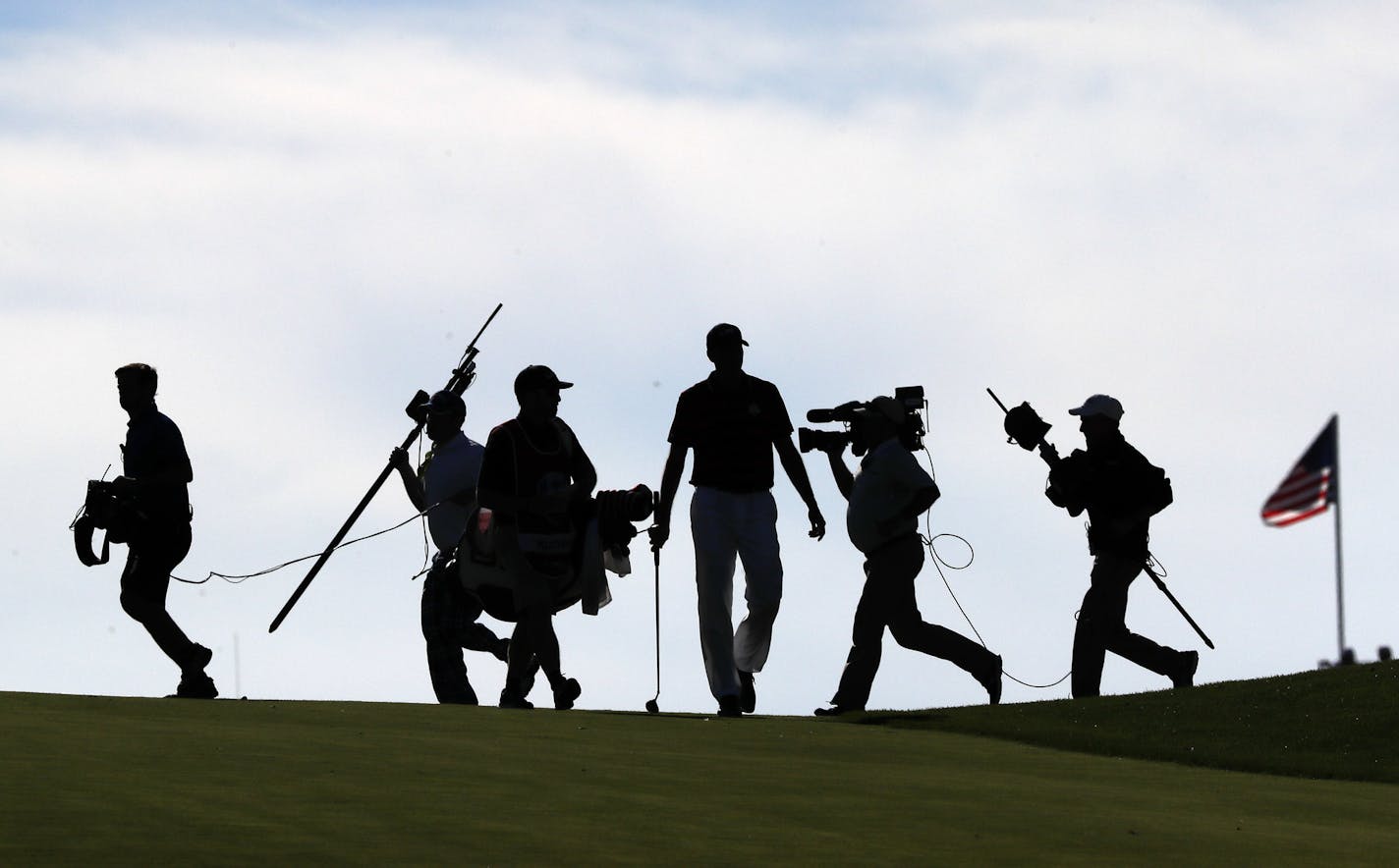 Matt Kucher walks the fairway after hitting his shot and the media coverage crew moves for the their next shot during the afternoon fourball play. ] JERRY HOLT jerry. Holt@Startribune.com The Ryder Cup Afternoon fourball play Saturday October 1, 2016 at Hazeltine National Golf Club in Chaska, Minn.