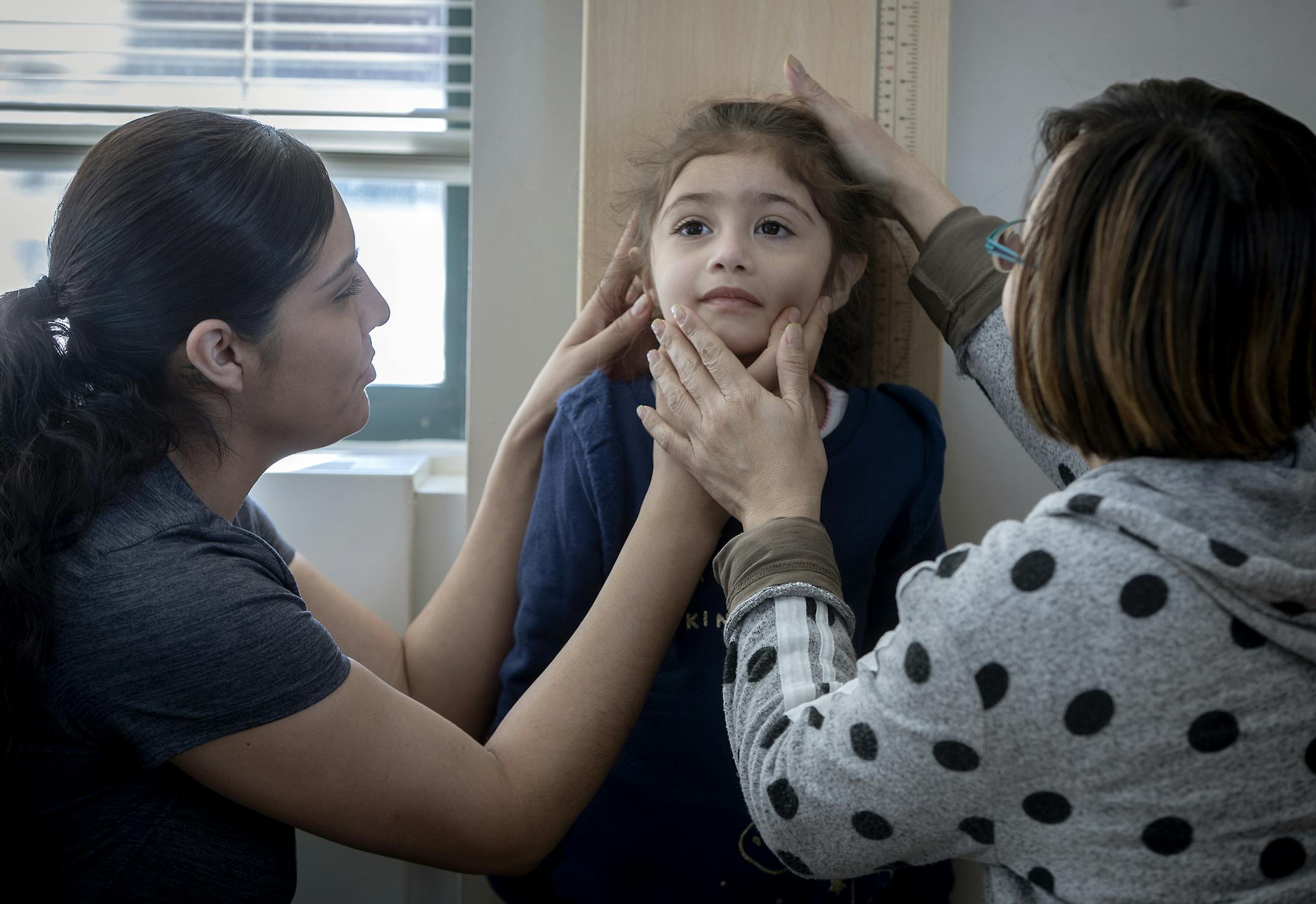 Ha-Vi Nguyen, right, a public health nutrition specialist, checked the height of Micaela, 3, with the help of her mother Jenny Valdez, during a WIC appointment, Friday, February 8, 2019 in Apple Valley, MN. ] ELIZABETH FLORES &#x2022; liz.flores@startribune.com