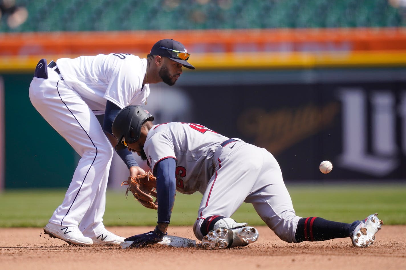 Detroit Tigers shortstop Willi Castro waits on the throw as Minnesota Twins' Byron Buxton takes second with a double during the fifth inning of a baseball game, Wednesday, April 7, 2021, in Detroit. (AP Photo/Carlos Osorio)