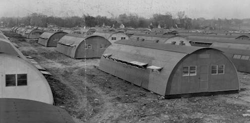 Rows of quonset hut housing shown from above.