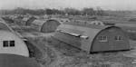 Rows of quonset hut housing shown from above.