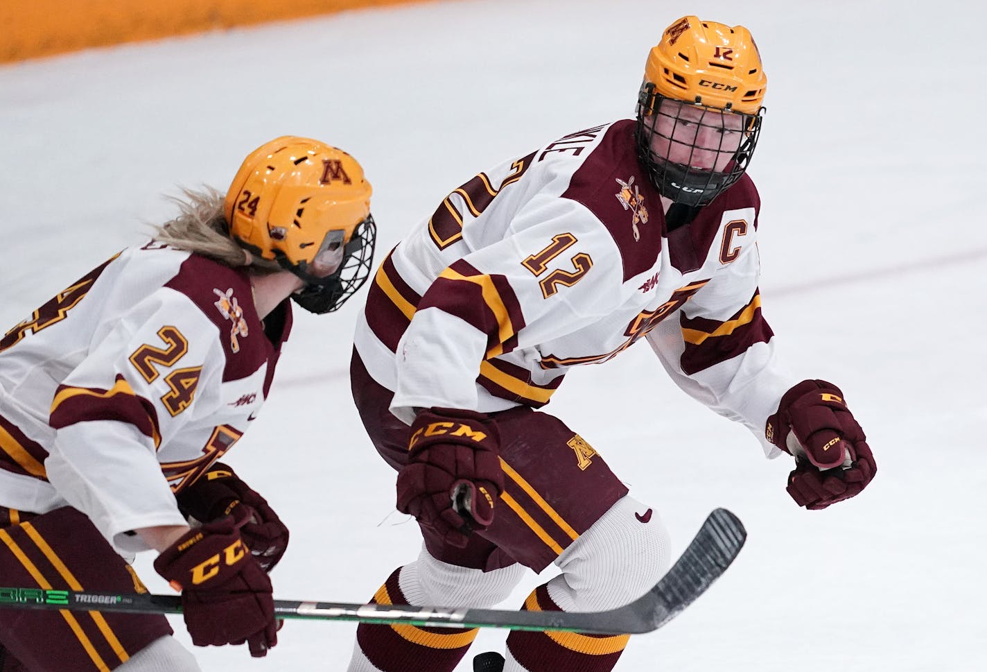 Minnesota forward Grace Zumwinkle (12) skated back to the bench to celebrate after she scored the game tying goal past Wisconsin goaltender Kennedy Blair (29) in the third period. ] ANTHONY SOUFFLE • anthony.souffle@startribune.com