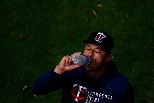 Minnesota Twins' Rob Refsnyder takes a drink during spring training baseball practice on Wednesday, Feb. 24, 2021, in Fort Myers, Fla. (AP Photo/Brynn