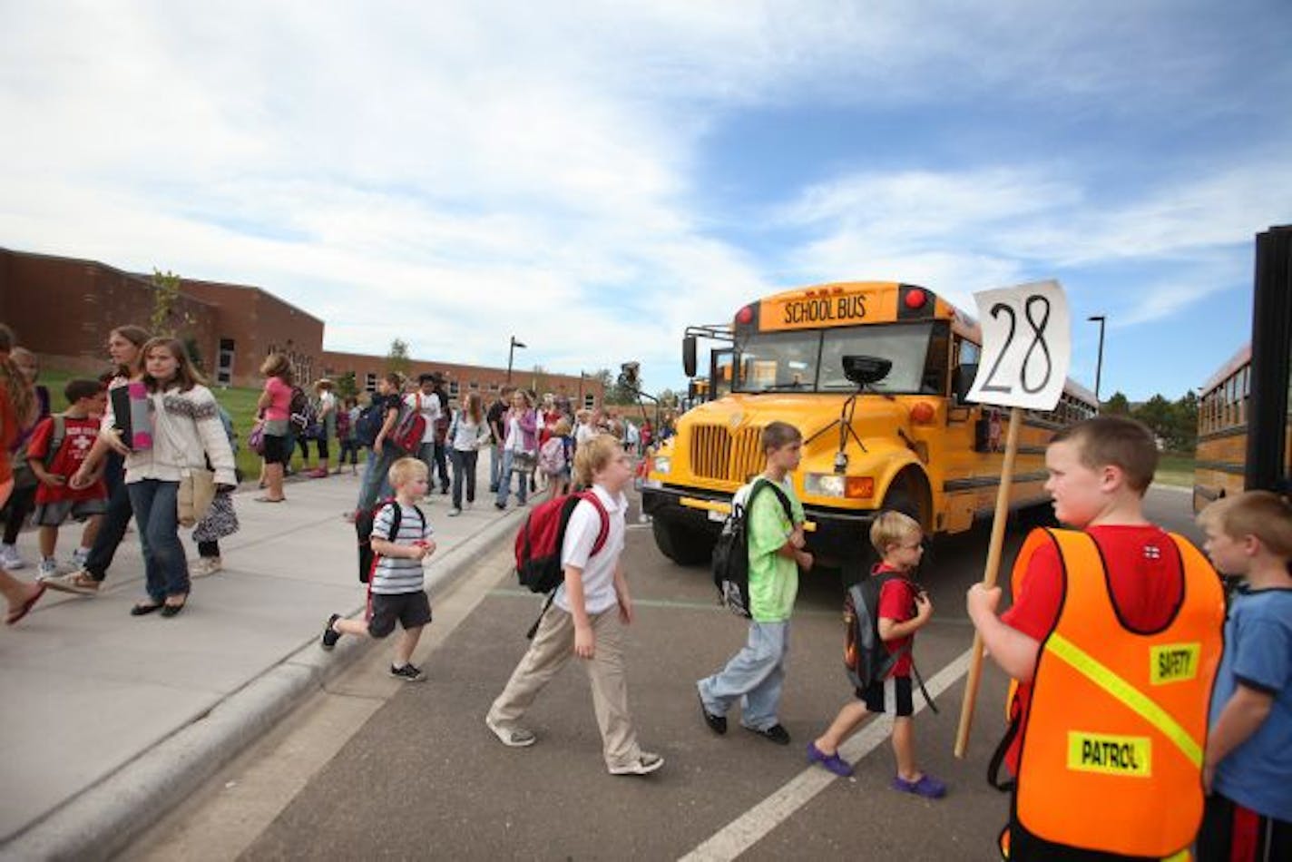 Hillside Elementary School students made their way to buses Thursday as they left their new school in New Richmond, Wis., that already is over capacity. The city of more than 8,000 is opening schools and remodeling others to accommodate the growth.