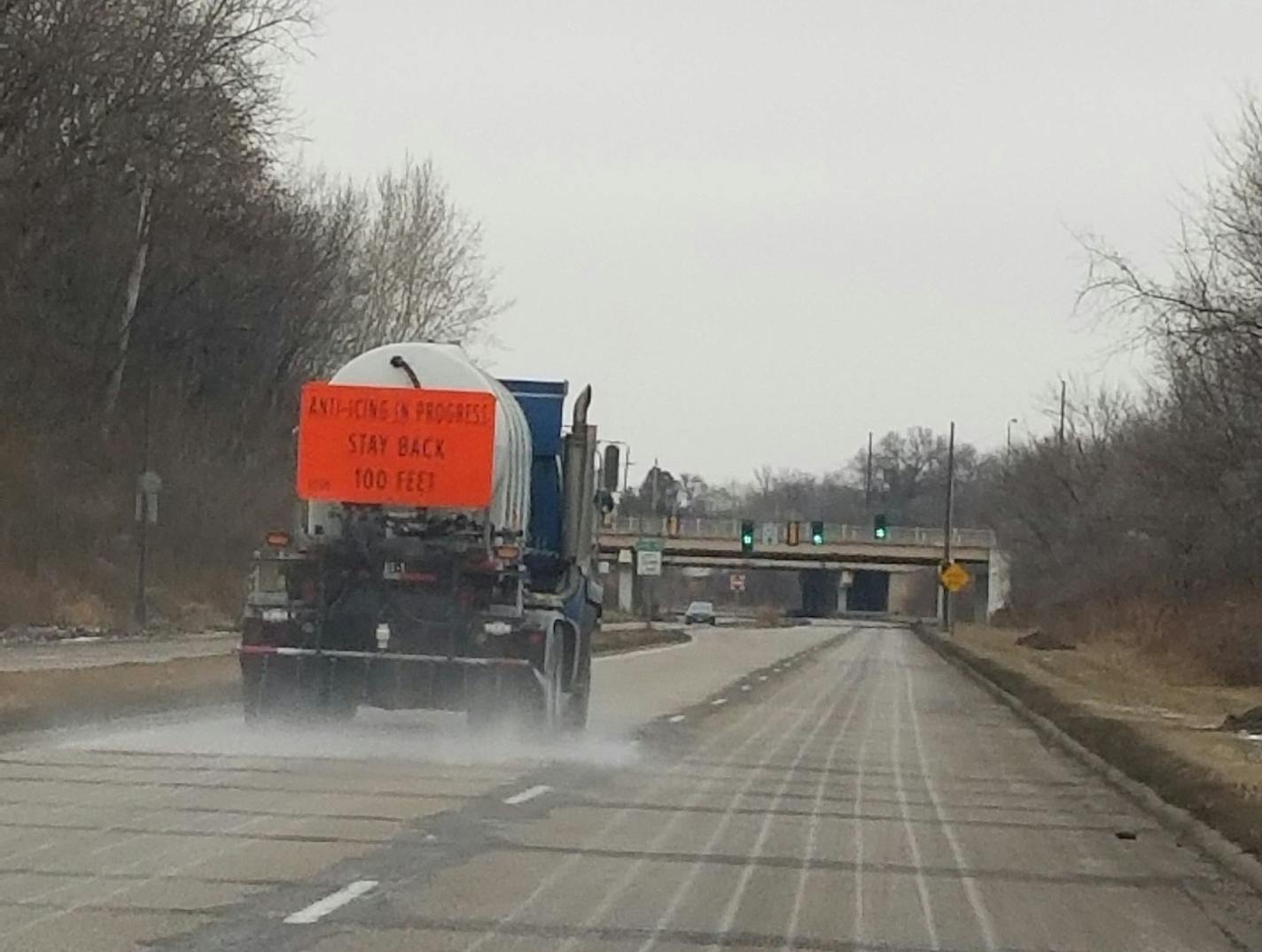 A St. Paul Public Works truck sprays de-icer on a road in anticipation of slick conditions.