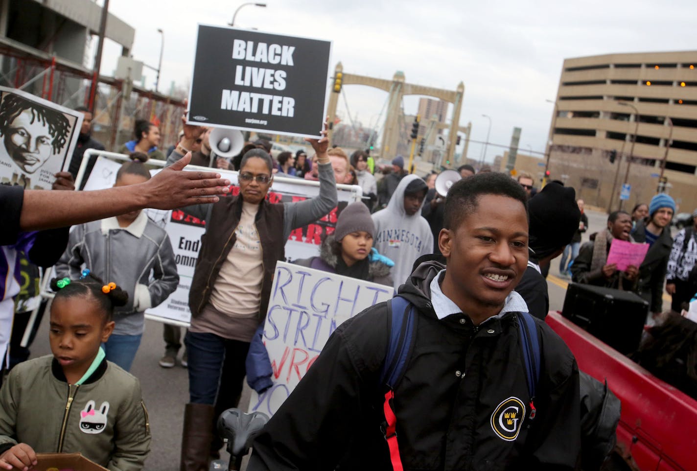 Black Lives Matter protesters head down Hennepin Ave., after converging at the County Government Center for a few hours of speakers before heading to the North Loop and back Saturday, March 26, 2016, in Minneapolis, MN.](DAVID JOLES/STARTRIBUNE)djoles@startribune.com Black Lives Matter protesters converged at the County Government Center to demand that officers Mark Ringgenberg and Dustin Schwarze, the men involved in Jamar Clark's shooting death, be charged with murder.