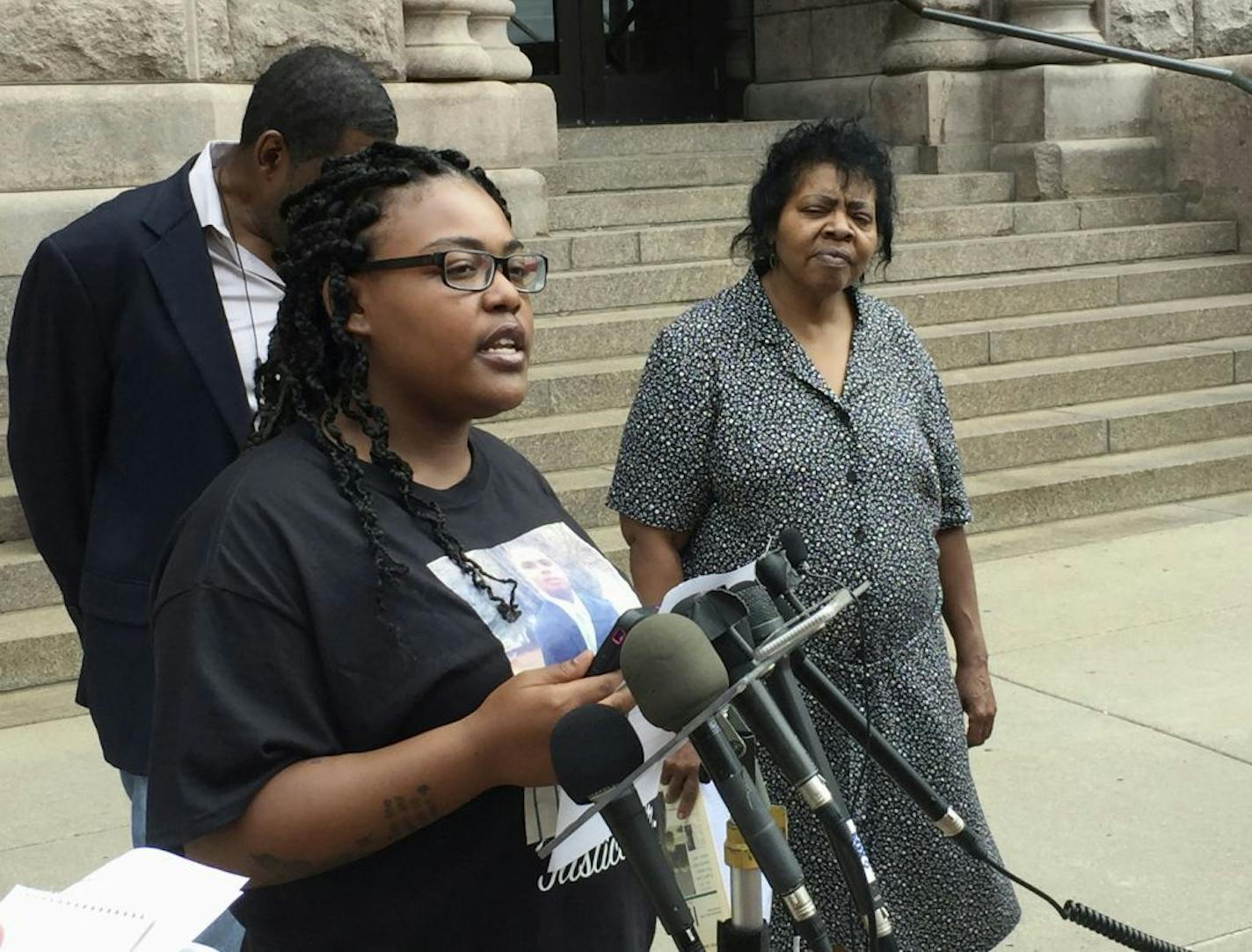 Sydney Brown, the cousin of Thurman Blevins, is joined other family members and activists Monday, July 9, 2018, to call for criminal charges against two Minneapolis police officers who fatally shot Blevins on June 23, 2018. Looking on are community activist Mel Reeves, left, and Blevins' aunt Jeanette Blevins, right.