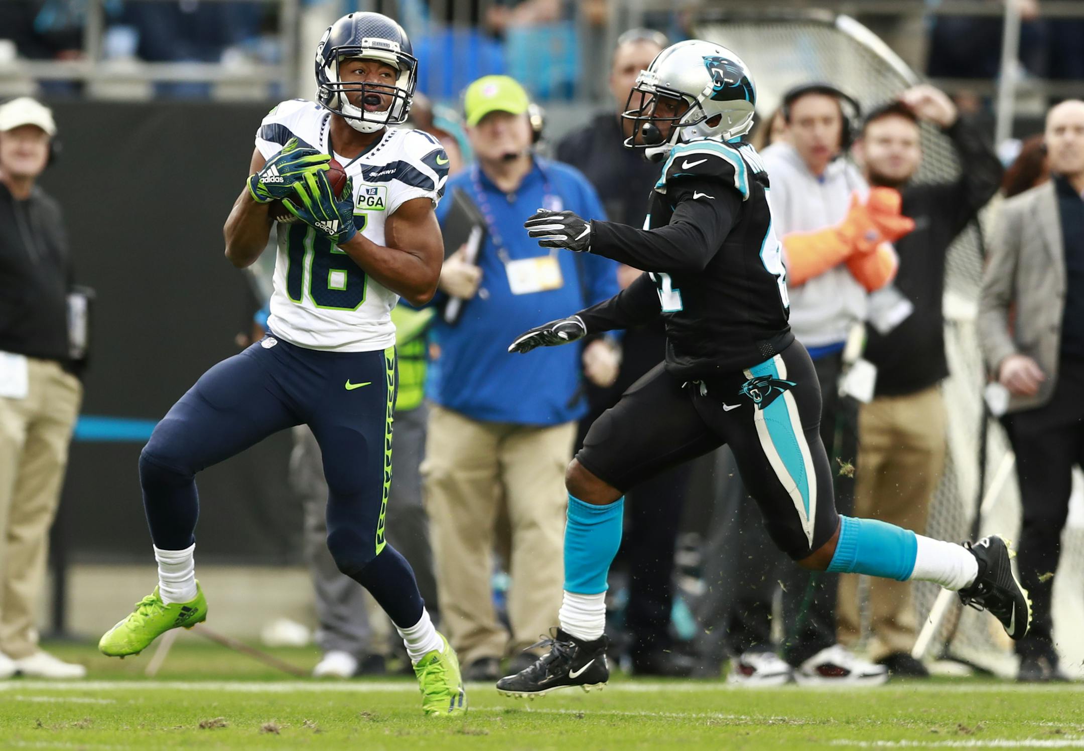 Seattle Seahawks' Tyler Lockett (16) catches a pass in front of Carolina Panthers' Captain Munnerlyn (41) during the second half of an NFL football game in Charlotte, N.C., Sunday, Nov. 25, 2018. (AP Photo/Jason E. Miczek)