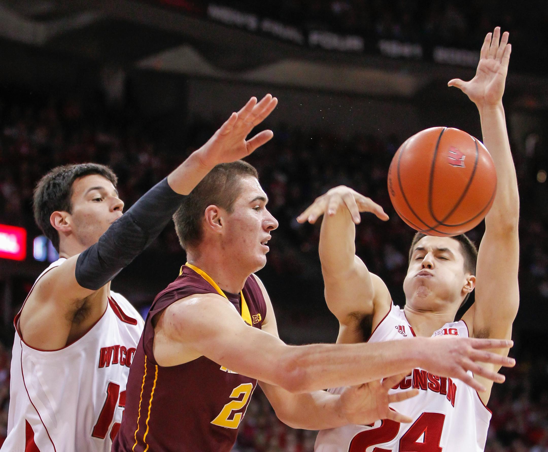 Wisconsin's Duje Dukan, left, and Bronson Koenig trap Minnesota's Joey King during the first half of an NCAA college basketball game Thursday, Feb. 13, 2014, in Madison, Wis. (AP Photo/Andy Manis)