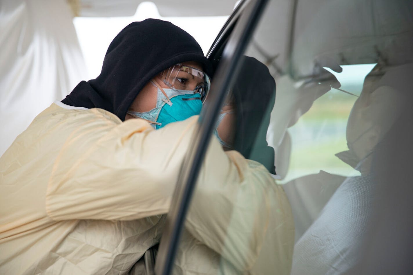 Cheryl Odegaard, a medical assistant at St. Luke's Respiratory Clinic, administered a COVID-19 test to a patient in their drive thru testing site in September. ALEX KORMANN • alex.kormann@startribune.com