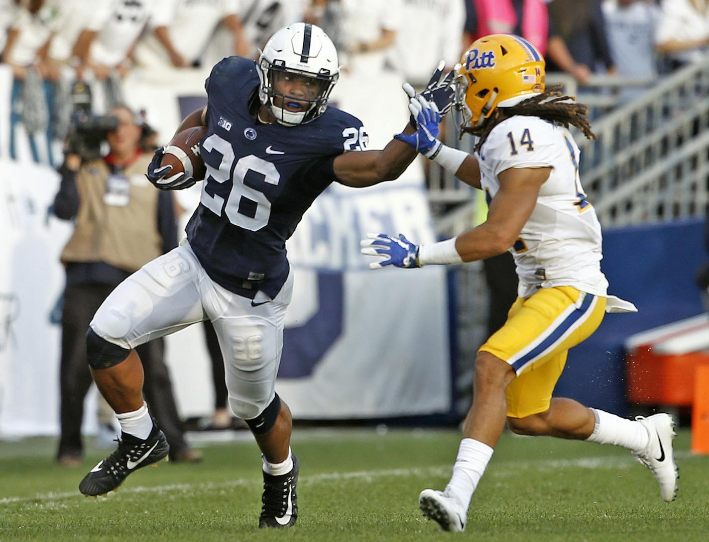 FILE - In this Saturday, Sept. 9, 2017, file photo, Penn State's Saquon Barkley (26) looks to stiff arm Pittsburgh's Avonte Maddox (14) during the second half of an NCAA college football game in State College, Pa. The fourth-ranked Nittany Lions (3-0) open Big Ten play against one of their most vexing conference rivals on Saturday, Iowa. (AP Photo/Chris Knight, File)