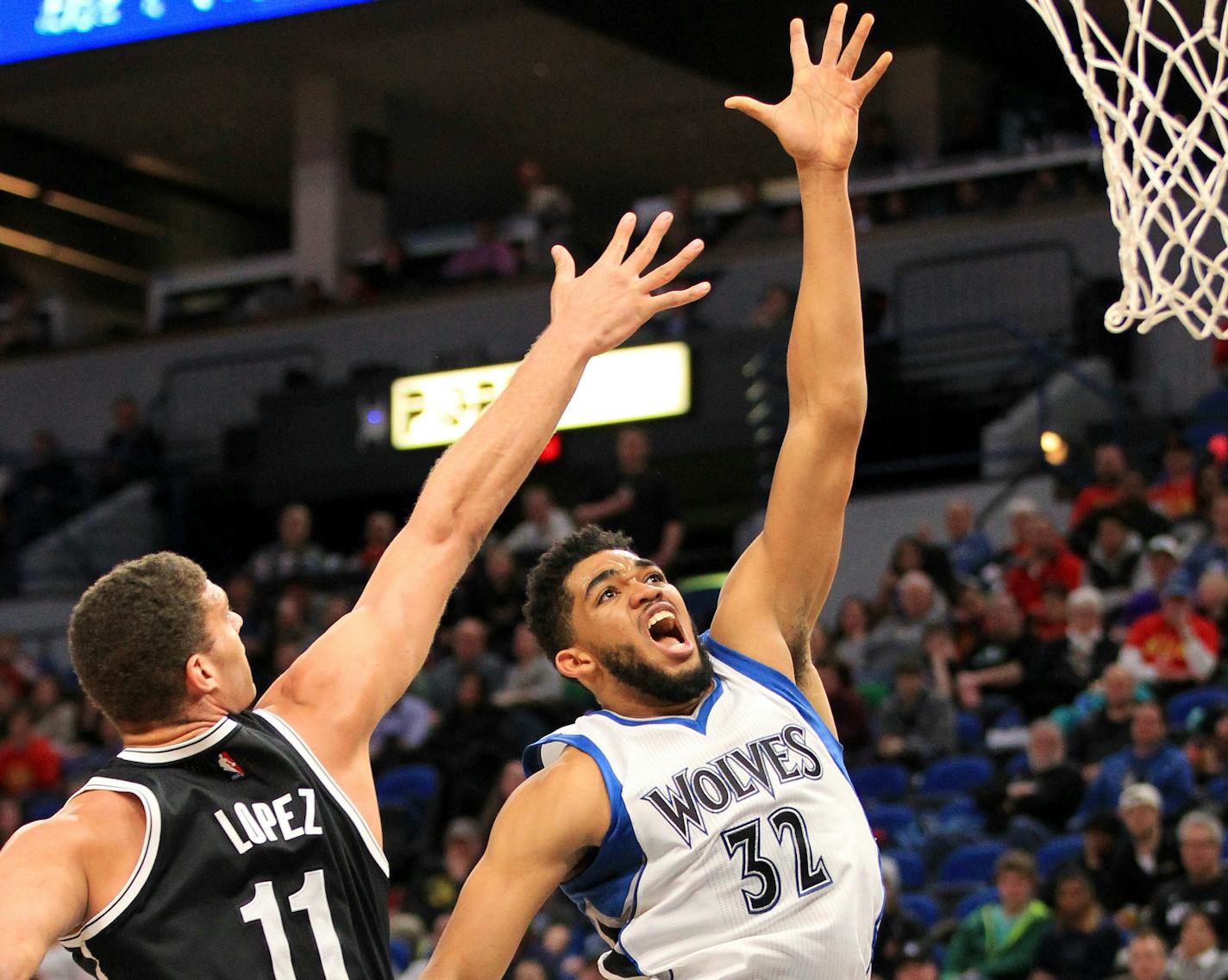 Minnesota Timberwolves center Karl-Anthony Towns (32) shoots next to Brooklyn Nets center Brook Lopez (11) during the third quarter of an NBA basketball in Minneapolis, Saturday, Jan. 28, 2017. The Timberwolves defeated the Nets 129-109. (AP Photo/Andy Clayton-King)