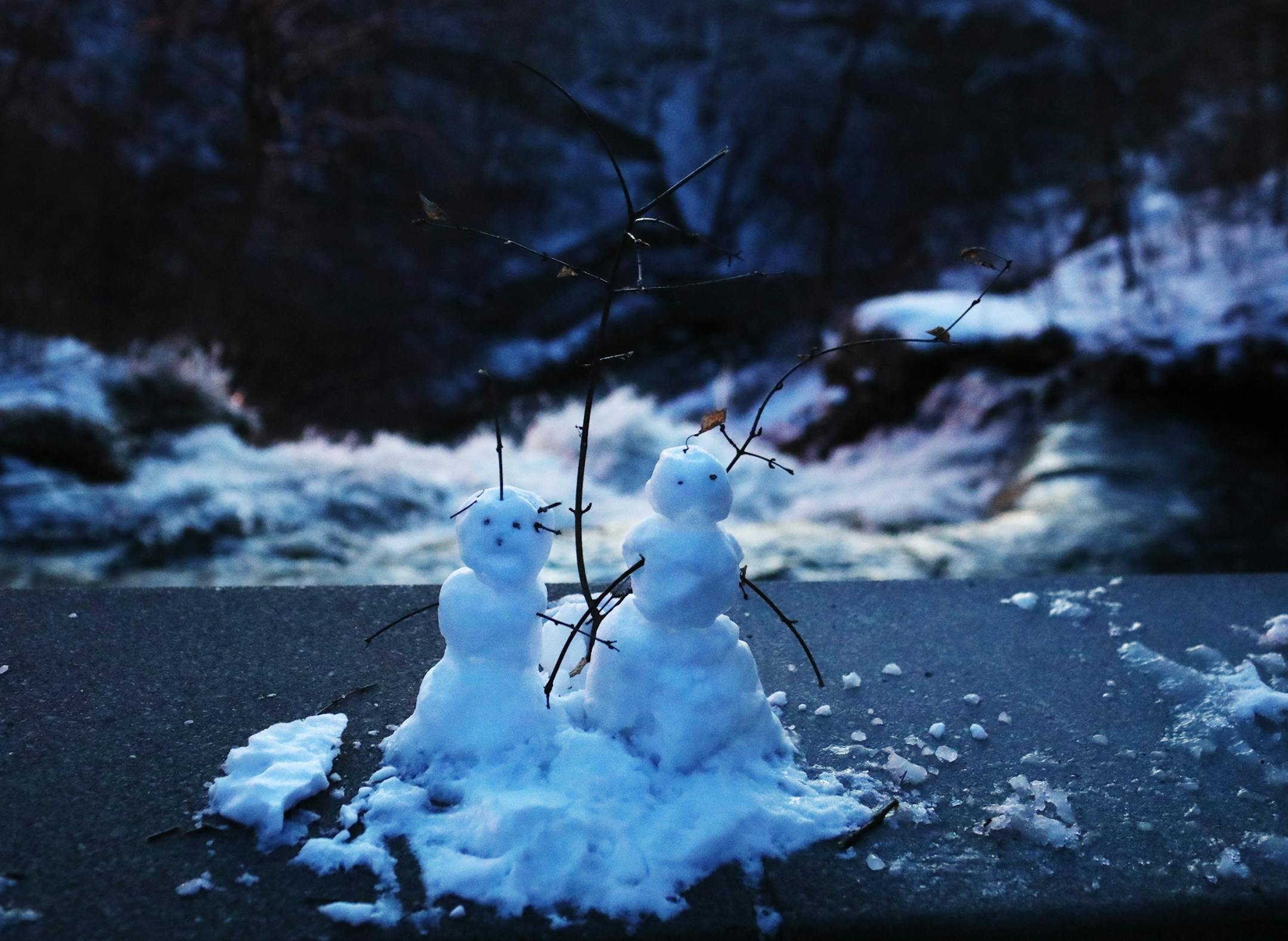 Mini snowmen sit on the bridge above Minnehaha Falls after a spring storm left several inches on Easter Sunday and seen Monday April 13, 2020, in Minneapolis, MN.