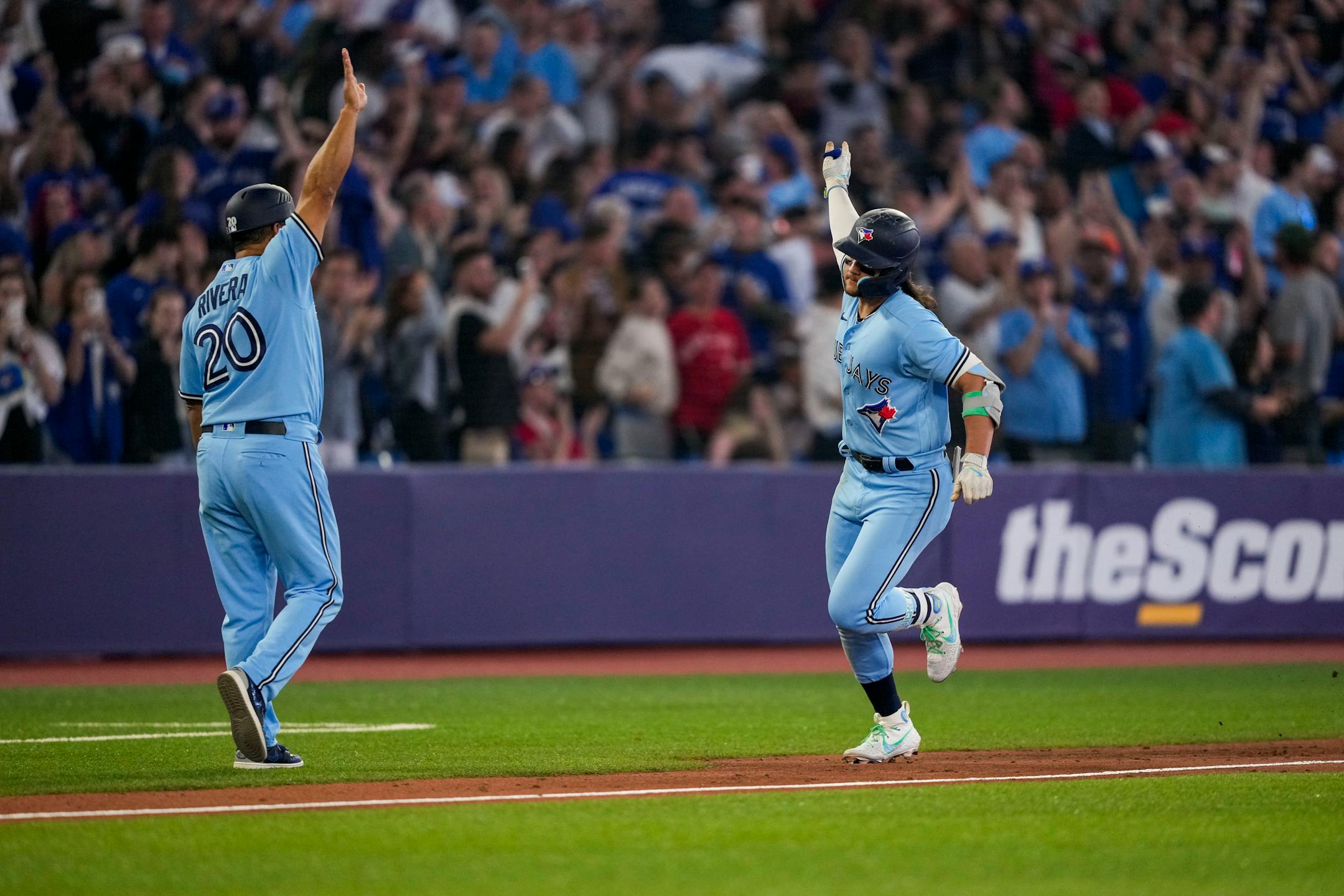 Toronto Blue Jays' Bo Bichette celebrates his home run against the Houston Astros with third base coach Luis Rivera (20) during the eighth inning of a baseball game Tuesday, June 6, 2023, in Toronto. (Andrew Lahodynskyj/The Canadian Press via AP)
