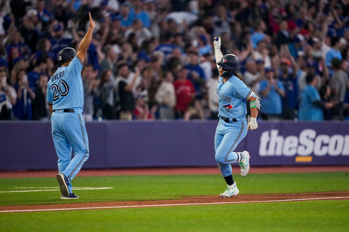 Toronto Blue Jays' Bo Bichette celebrates his home run against the Houston Astros with third base coach Luis Rivera (20) during the eighth inning of a baseball game Tuesday, June 6, 2023, in Toronto. (Andrew Lahodynskyj/The Canadian Press via AP)