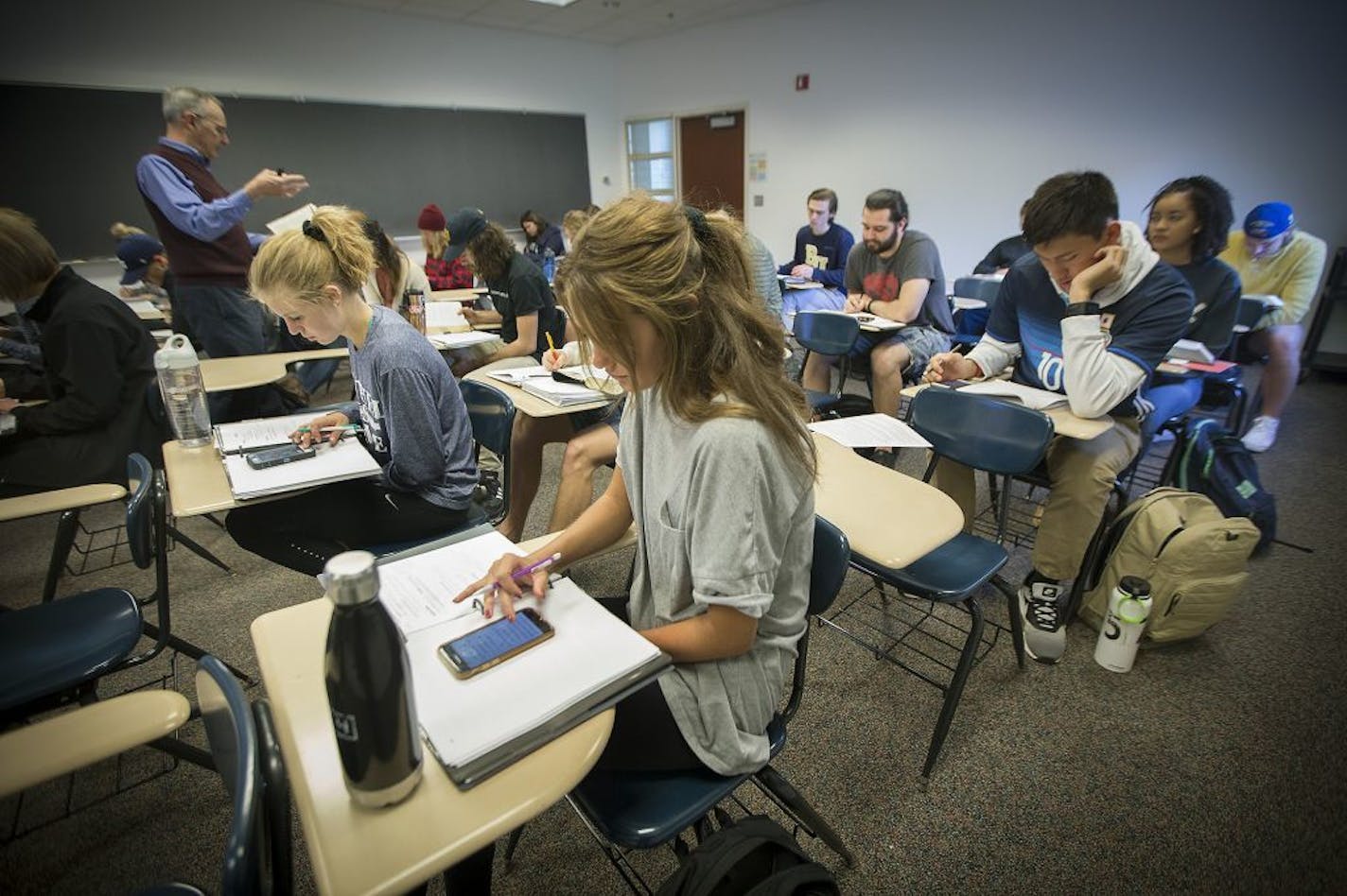 Bethel University students in Prof. Mike Holmes' Introduction to Bible Studies class use their cell phone Bible apps to follow him while he uses a Bible during a class, on May 3 in Arden Hills.