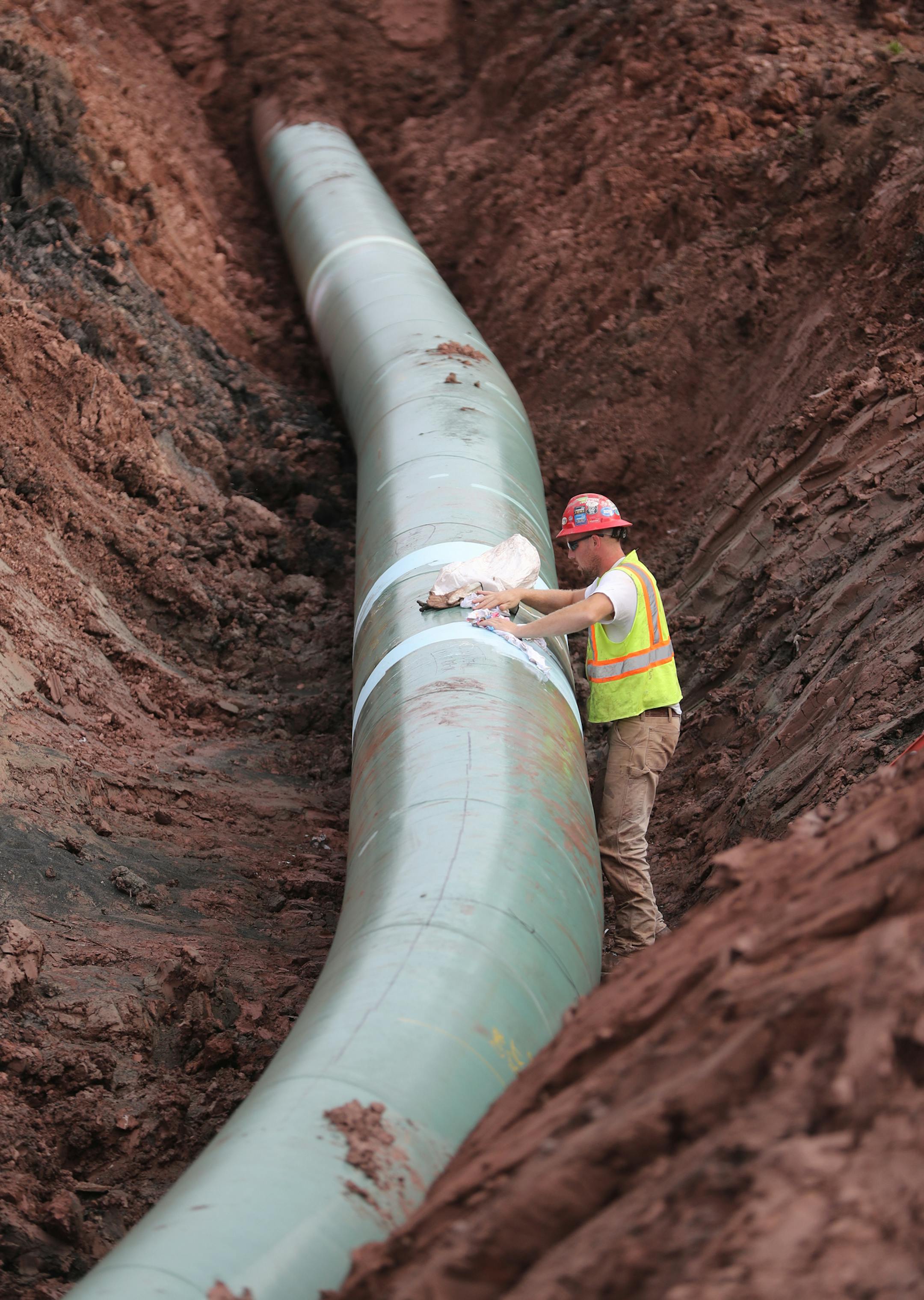A pipe fitter lays the finish finishing touches to the replacement of Line 3 stretch before it is covered up.]Enbridge already has started building the 14-mile stretch of Line 3 from the Minnesota line to its terminal in Superior, Wis.Richard Tsong-Taatarii ï richard.tsong-taatarii@startribune.com