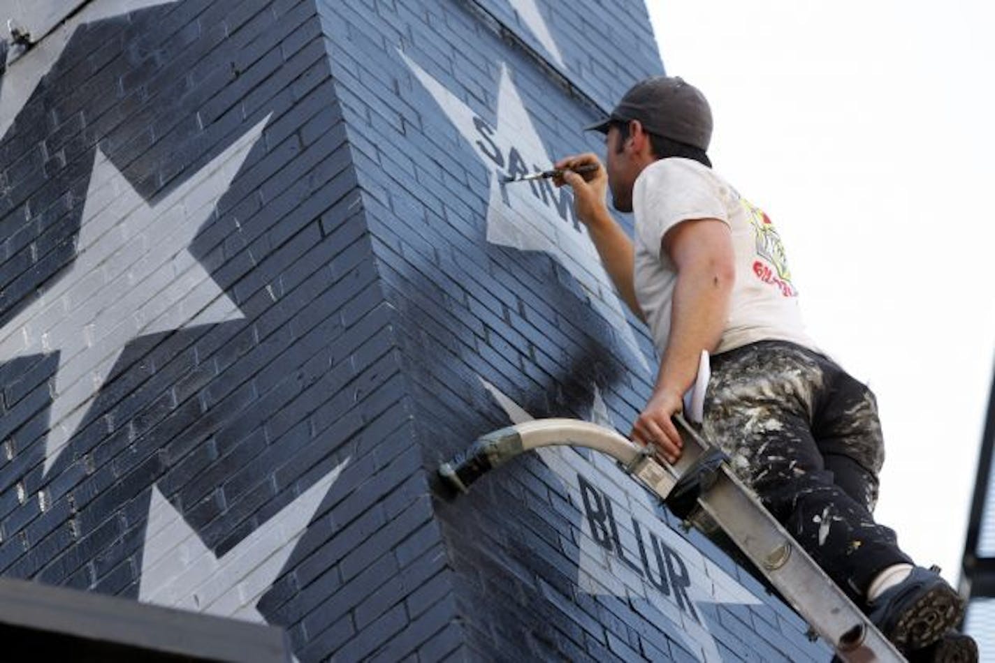 New stars at First Avenue, Berry Newman started hand-painting the names of the 400 musical acts that will decorate the exterior walls of First Avenue.