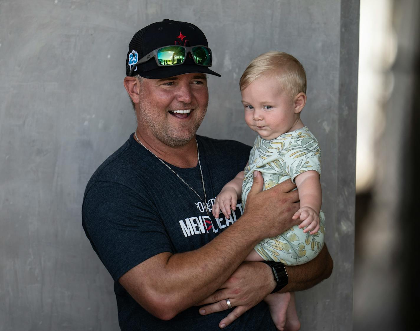 St. Paul Saints manger Toby Gardenhire, held his 8 month old son Bodie , as they watched batting practiceTuesday , Feb.21.2023 in Fort Myers, Fla. ] JERRY HOLT • jerry.holt@startribune.com