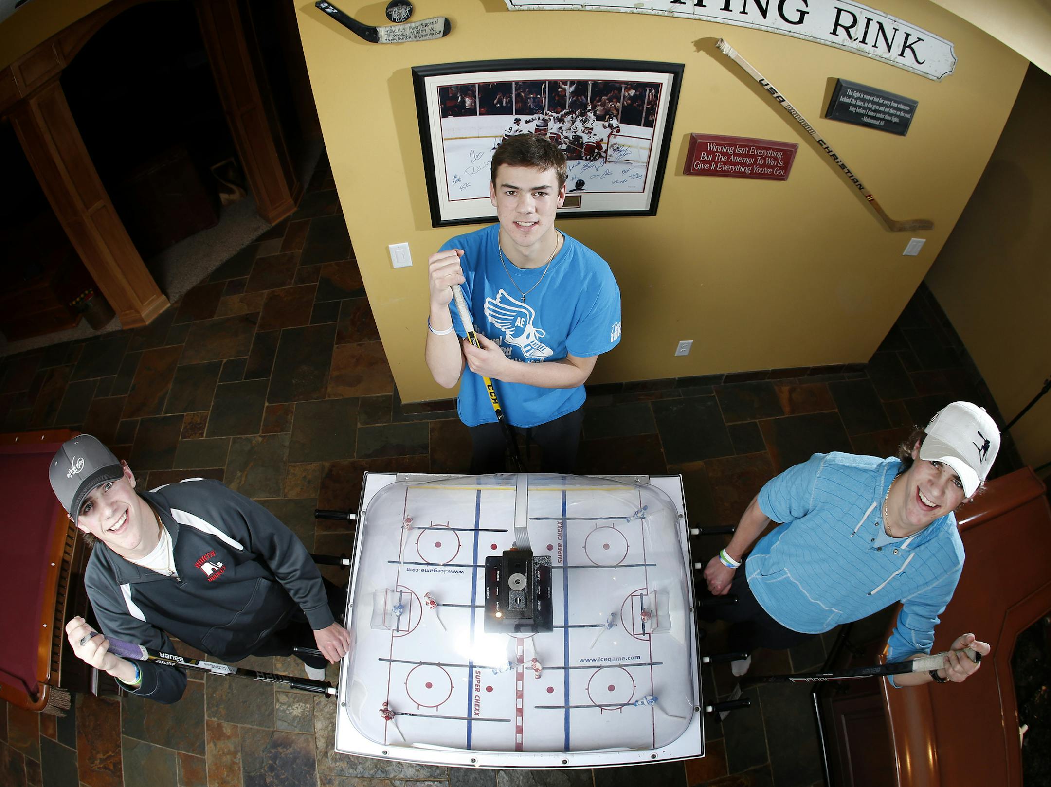 Even at home, hockey sticks and table hockey games are close by Lakeville North's Poehling brothers, from left, senior Nick, sophomore Ryan and senior Jack.
