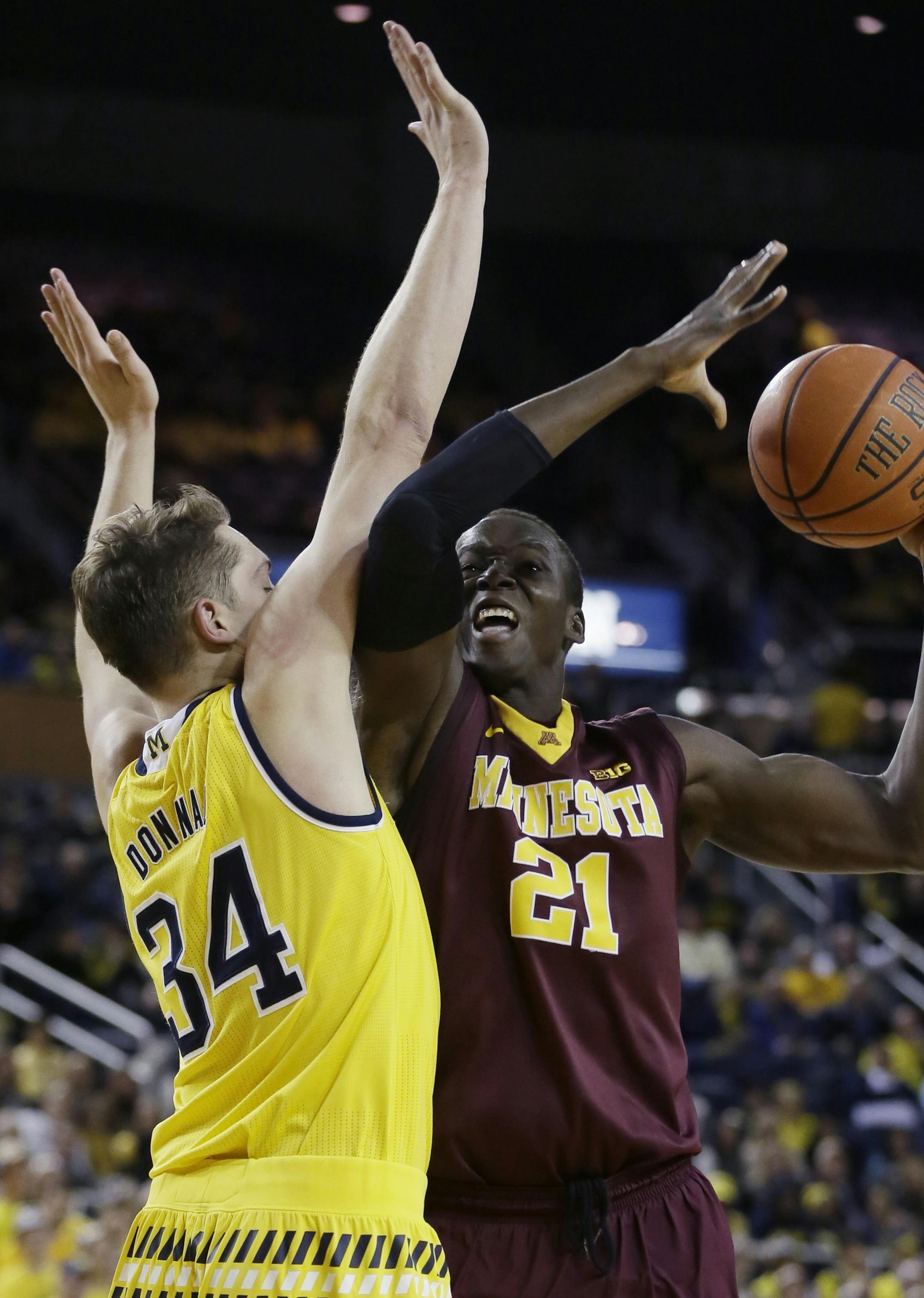 Minnesota center Bakary Konate (21) is defended by Michigan forward Mark Donnal (34) during the first half of an NCAA college basketball game, Wednesday, Jan. 20, 2016 in Ann Arbor, Mich. (AP Photo/Carlos Osorio)