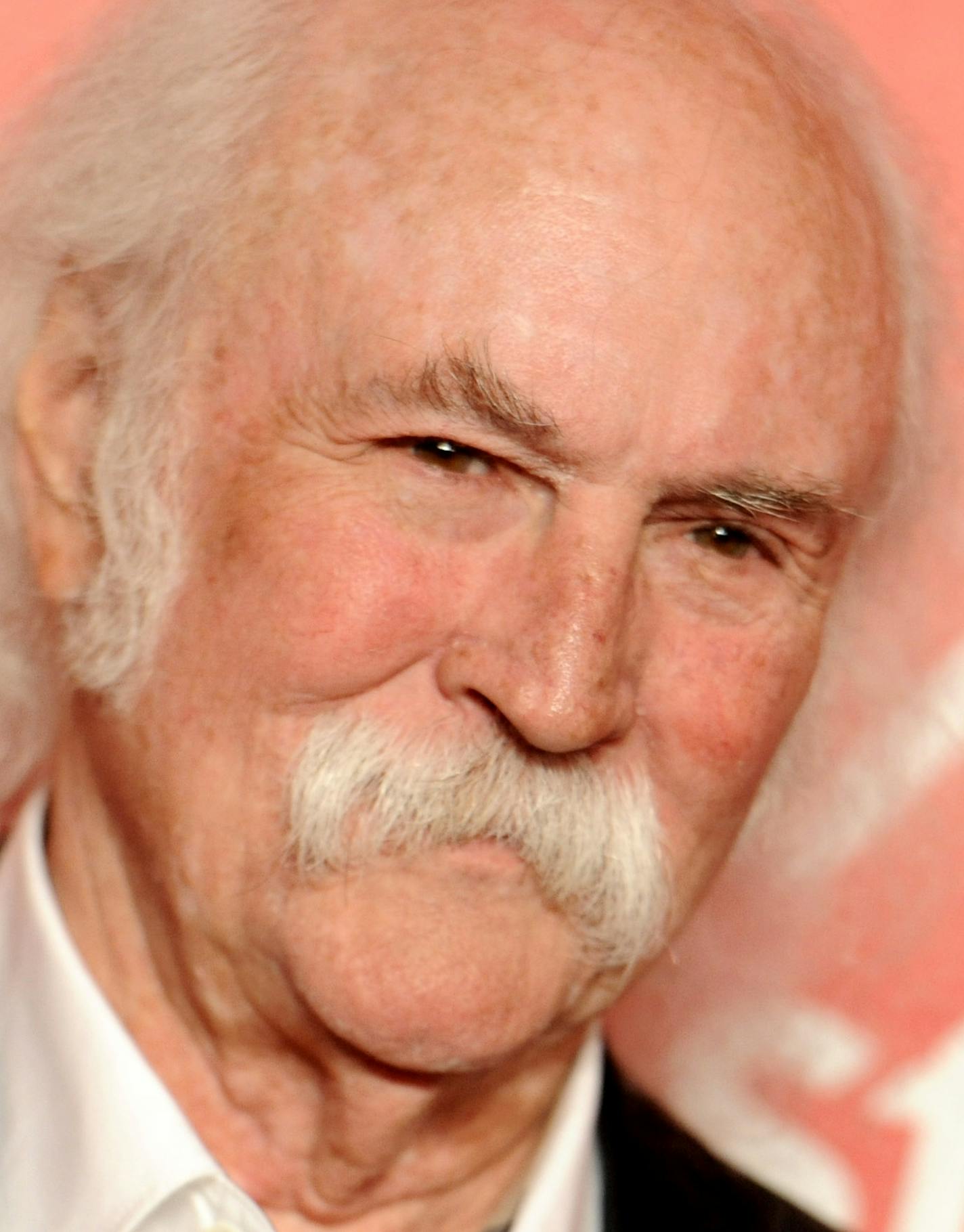 FILE - In this Feb. 6, 2015 file photo, David Crosby arrives at the 2015 MusiCares Person of the Year event at the Los Angeles Convention Center in Los Angeles. The Rock and Roll Hall of Famer Crosby hit and injured a jogger with his car in Southern California. The California Highway Patrol said in a statement that Crosby was driving his Tesla electric car Sunday, March 22, 2015, at around 55 mph, the posted speed limit on the road in the Santa Barbara area where Crosby lives. (Photo by Richard