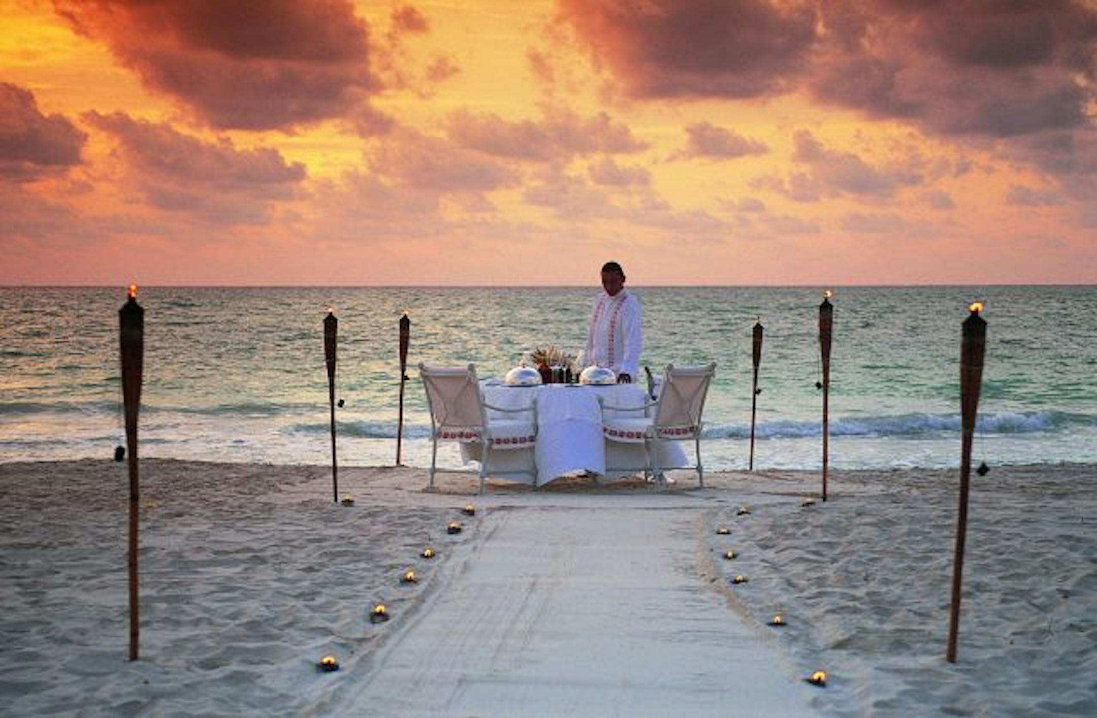 The first luxury resort on Mexico's Riviera Maya, Maroma capitalizes on its stunning Caribbean location to provide romantic opportunities for its guests. Above, a server puts the finishing touches on a private beachside dinner for two.
