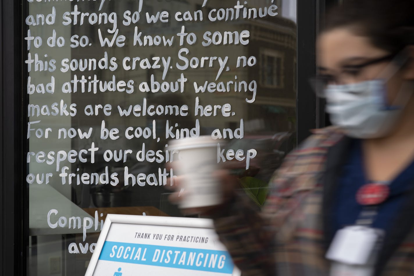 A hand lettered statement imploring customers of Youngblood Coffee Roasters in downtown Fargo to respect the mask mandate.