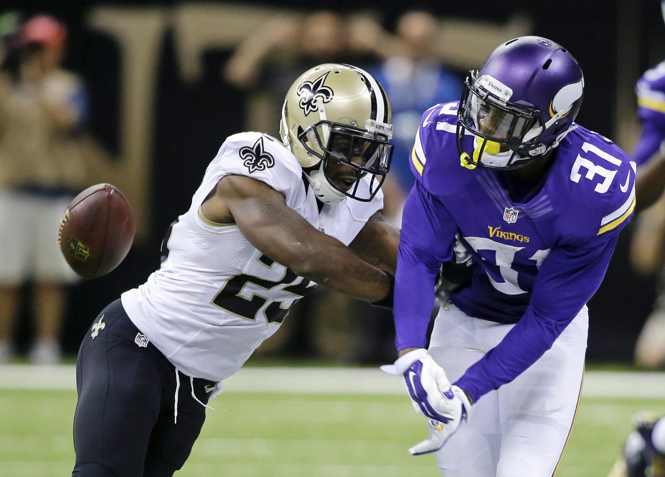 New Orleans Saints free safety Rafael Bush (25) breaks up a pass intended for Minnesota Vikings running back Jerick McKinnon (31) in the second half of an NFL football game in New Orleans, Sunday, Sept. 21, 2014. (AP Photo/Bill Haber)