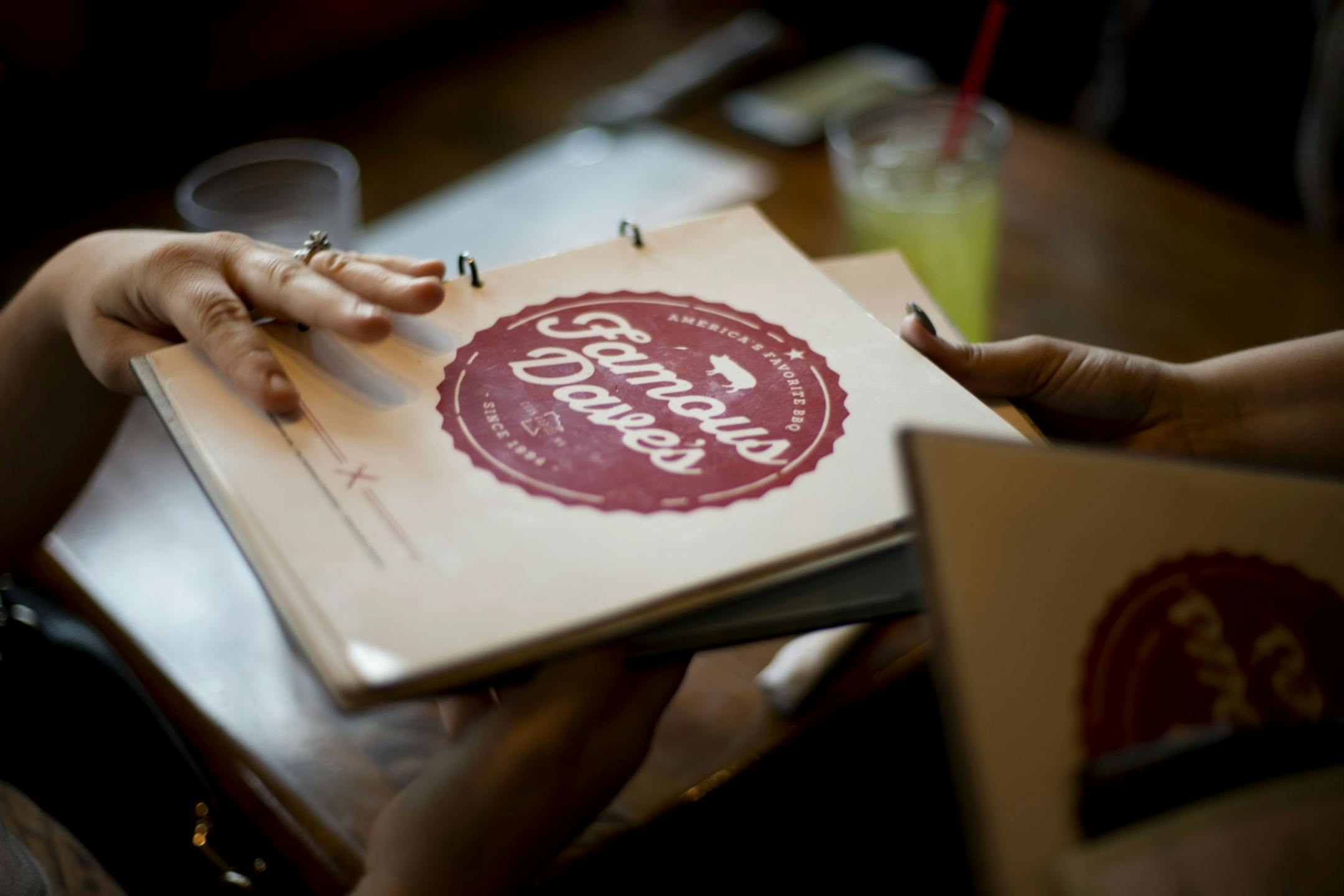 Erinn Weinmann hands back menus to Griffin Jess, the waitress, after ordering.