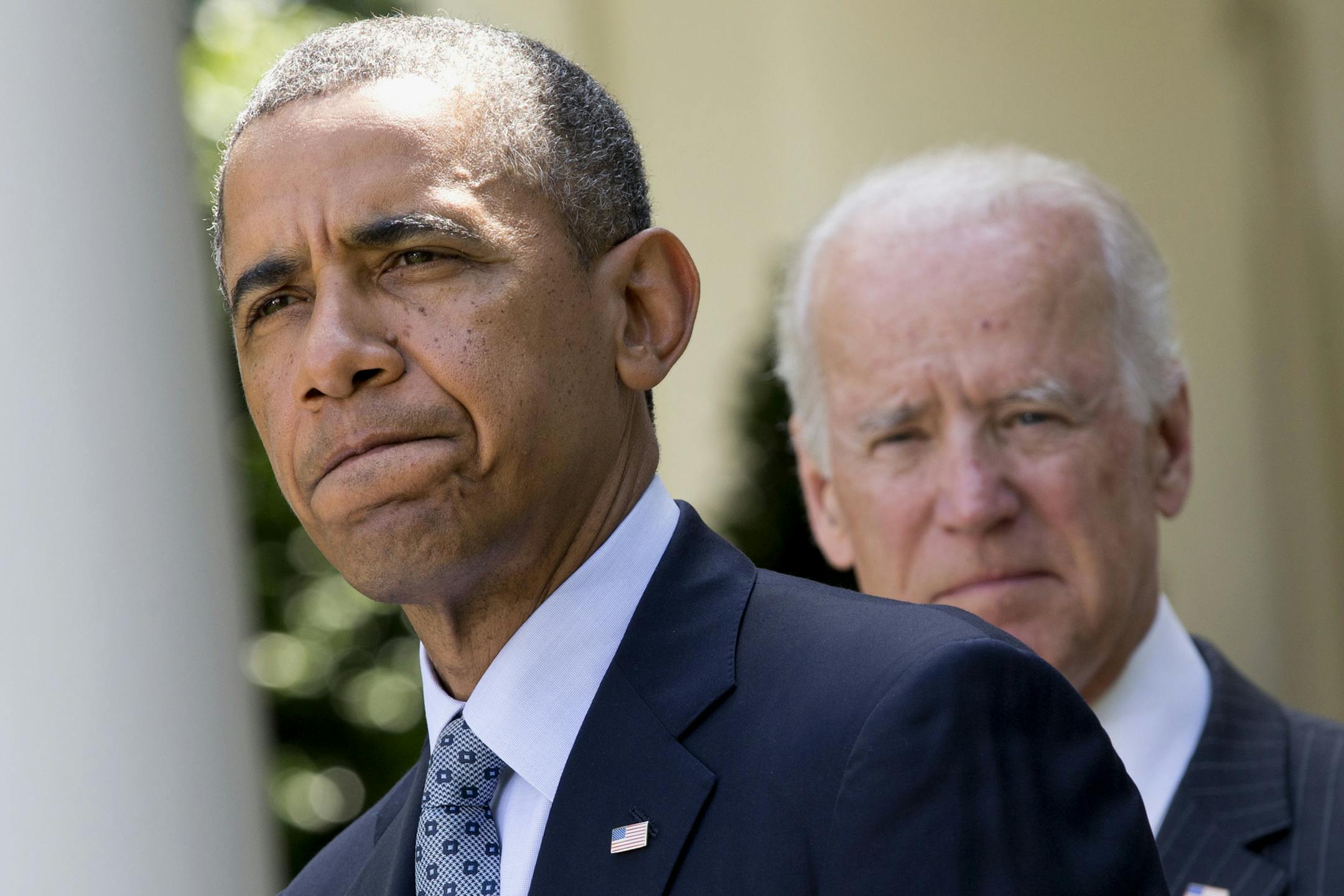 President Barack Obama, accompanied by Vice President Joe Biden, pauses while making an announcement about immigration reform, Monday, June 30, 2014, in the Rose Garden of the White House in Washington. The president said he's done waiting for House Republicans to act on immigration. He says he now plans to act on his own. Obama announced his intention Monday to take executive action. (AP Photo/Jacquelyn Martin)