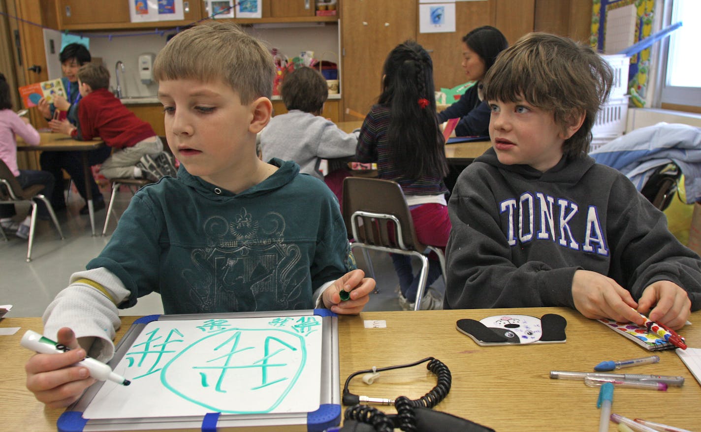 Excelsior Elementary first-graders Parker Nelson and Sam Glenn worked on their Mandarin Chinese characters during Ming Yan's class. In immersion programs such as the ones started in the Minnetonka and Hopkins districts, all subjects — even writing — are taught in the language.