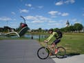 Bicyclists rode through the Minneapolis Sculpture Garden on Thursday, August 8, 2019. With Southwest Light Rail Construction, bikers that typically co