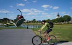 Bicyclists rode through the Minneapolis Sculpture Garden on Thursday, August 8, 2019. With Southwest Light Rail Construction, bikers that typically co