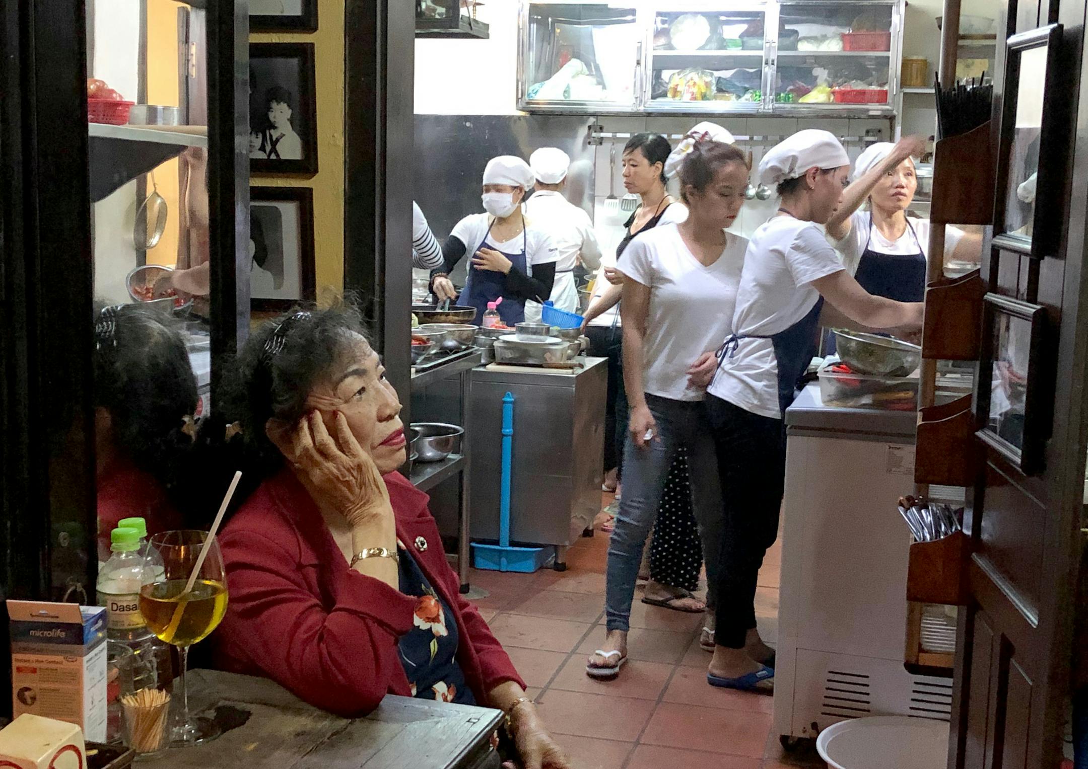 Ms Ly's (Miss LY CAFE) restaurant is well know in Hoi Ann. Her husband runs the front of the house and her mother has lived in the house since 1949. A very small kitchen turns out amazingly good food. I was there at the end of February and left right before the Seoul airport shut down.//Can I have your name as you would like it to appear in print, and the town in which you live? Bonnie Dickel Hoffman Golden Valley Do you know the name of the person in the foreground? Yes,Miss Ly, owner of Miss L