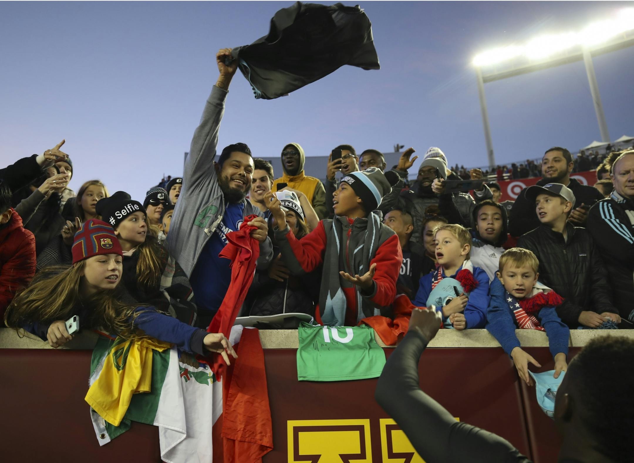 A lucky fan caught a jersey tossed up by Minnesota player Abu Danladi as he walked off the field.