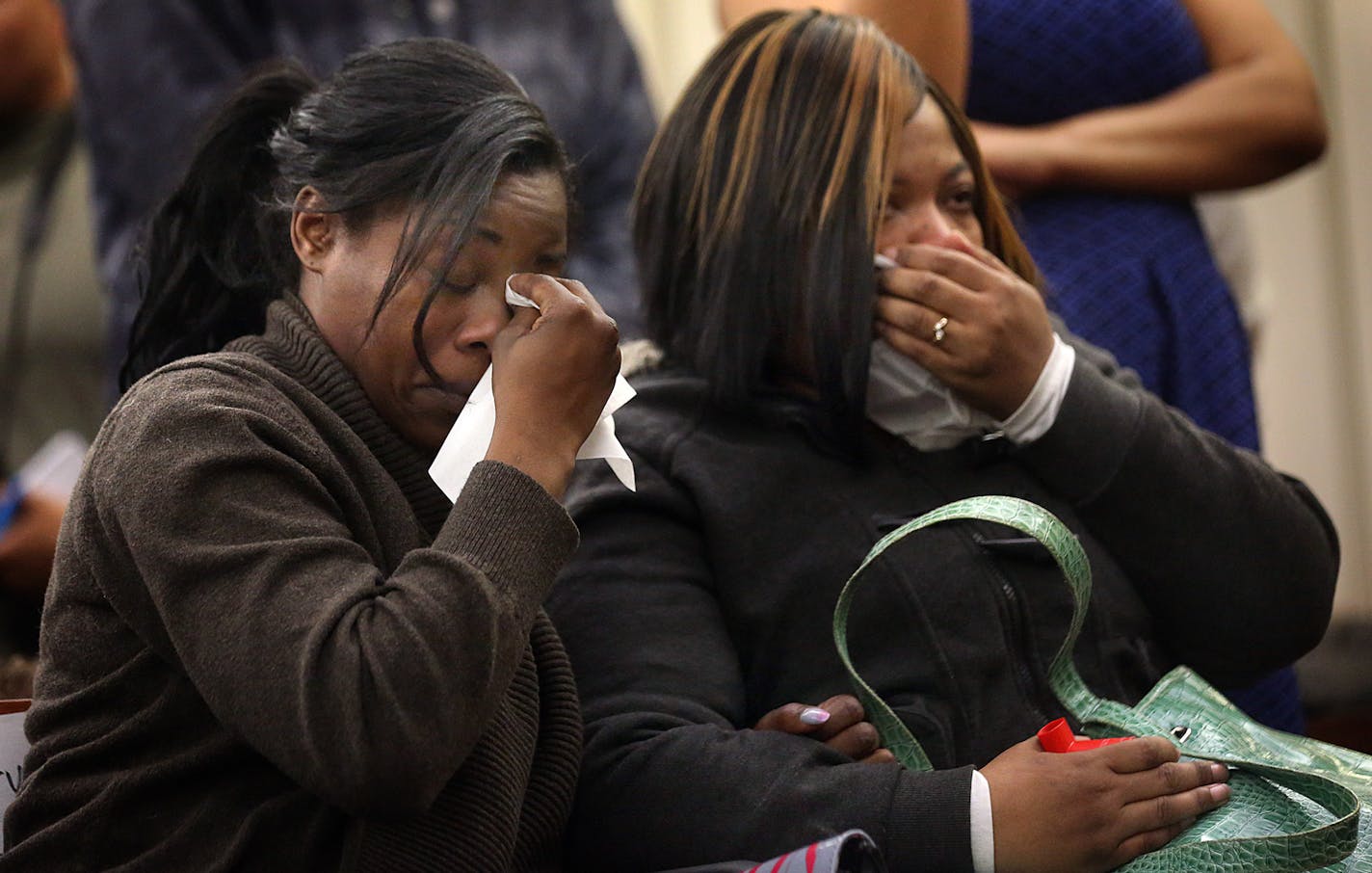 Tiffany Roberson (left) and Sharice Burns, sisters of Jamar Clark, watched a video taken at the scene where he was killed. Hennepin County Attorney Mike Freeman said that he will not file criminal charges against the two police officers involved in the shooting. ] JIM GEHRZ &#xef; james.gehrz@startribune.com /Minneapolis, MN / March 30, 2016 9:30 AM - BACKGROUND INFORMATION: Hennepin County Attorney Mike Freeman announced his decision on whether to criminally charge police officers in the shooti