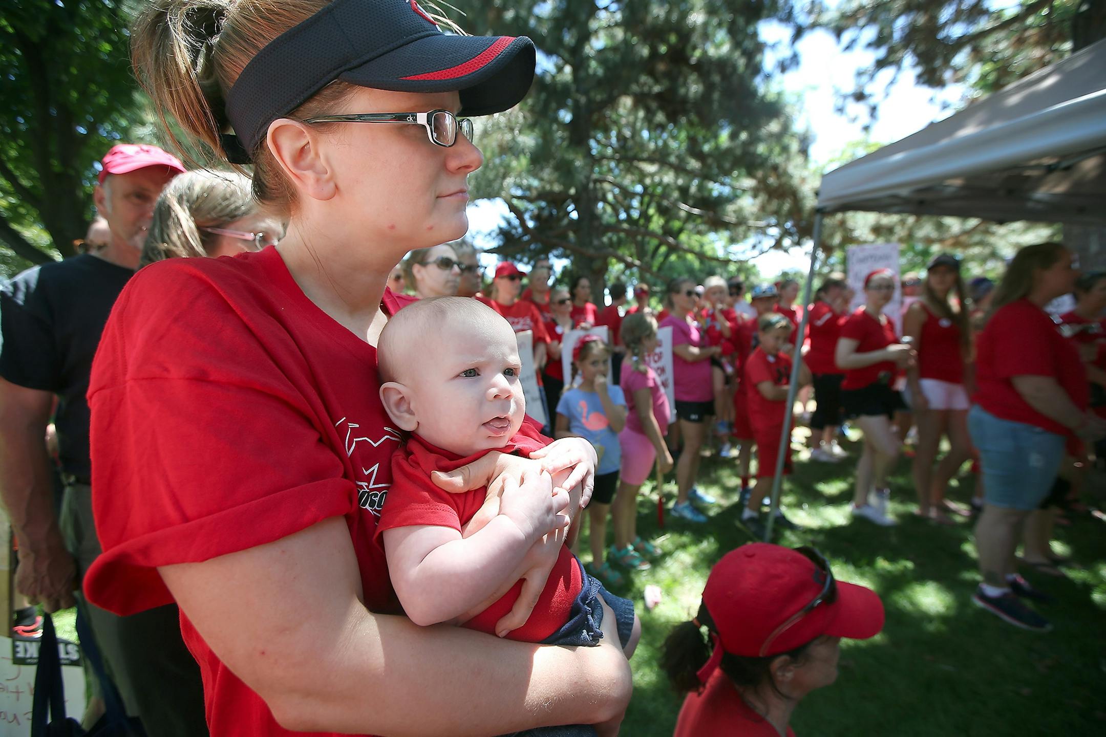 Melisa Anderson, cq, and her 4-month-old son Lucas listened to a press conference by the Members of the Minnesota Nurses Association outside Abbott Northwestern Hospital as they continued their strike, Monday, June 20, 2016 in Minneapolis, MN. Anderson is a nurse at the Mother/Baby Center at Abbott Northwestern.