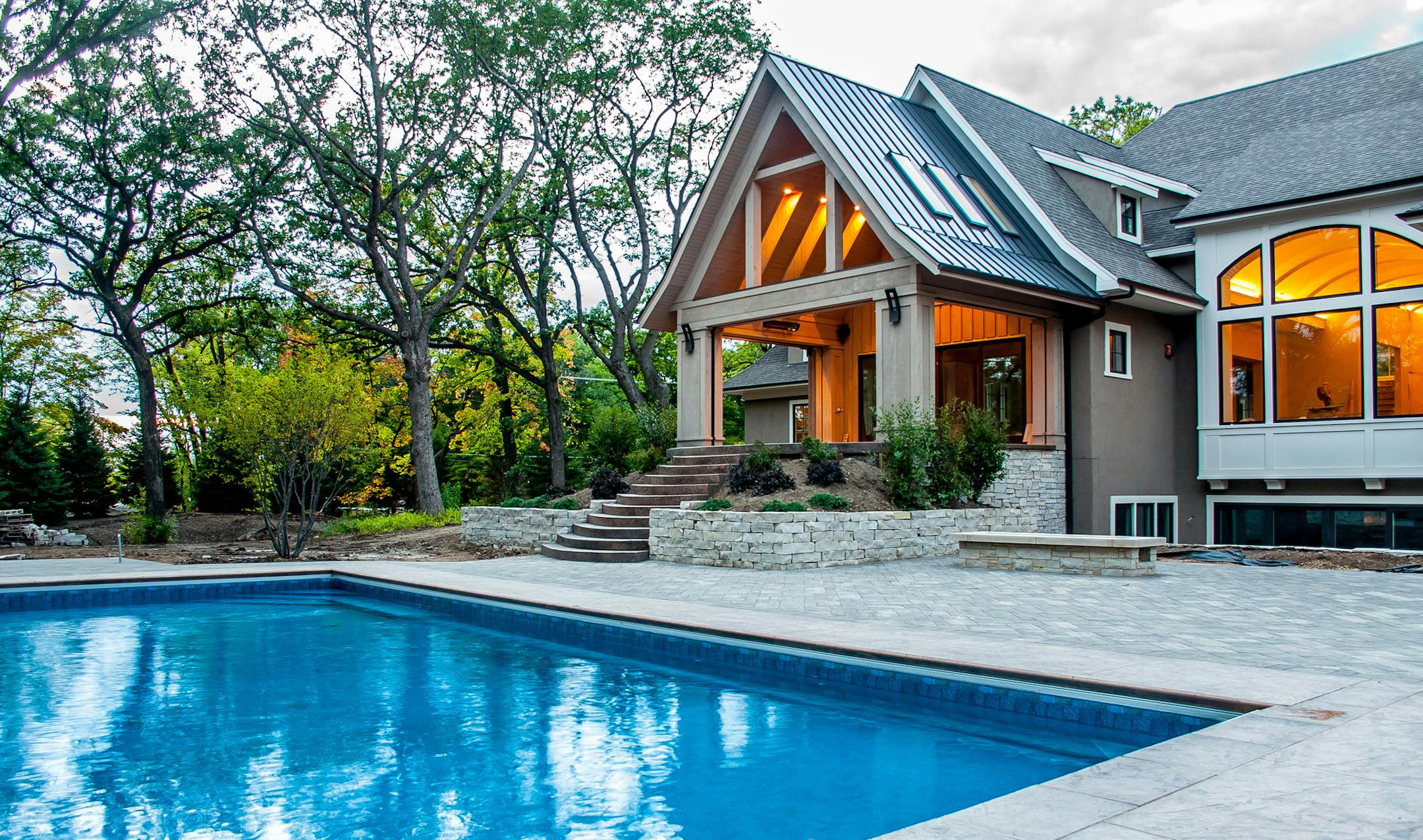 House in Wayzata by Jyland Construction features a variety of outdoor living spaces.