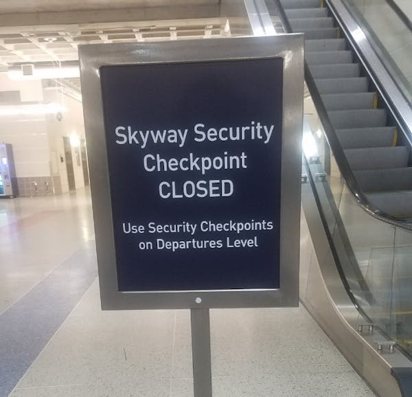 A sign tells passengers to proceed to security checkpoints on the departure level at Terminal 1.