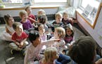 Children gathered and listened as teacher Kelli Kern read a book aloud. Kern, who has worked at the Child Development Center for 30 years, said, "If y