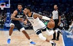 Mavericks forward Sterling Brown defends as Timberwolves guard D'Angelo Russell handles the ball in the second half Tuesday.