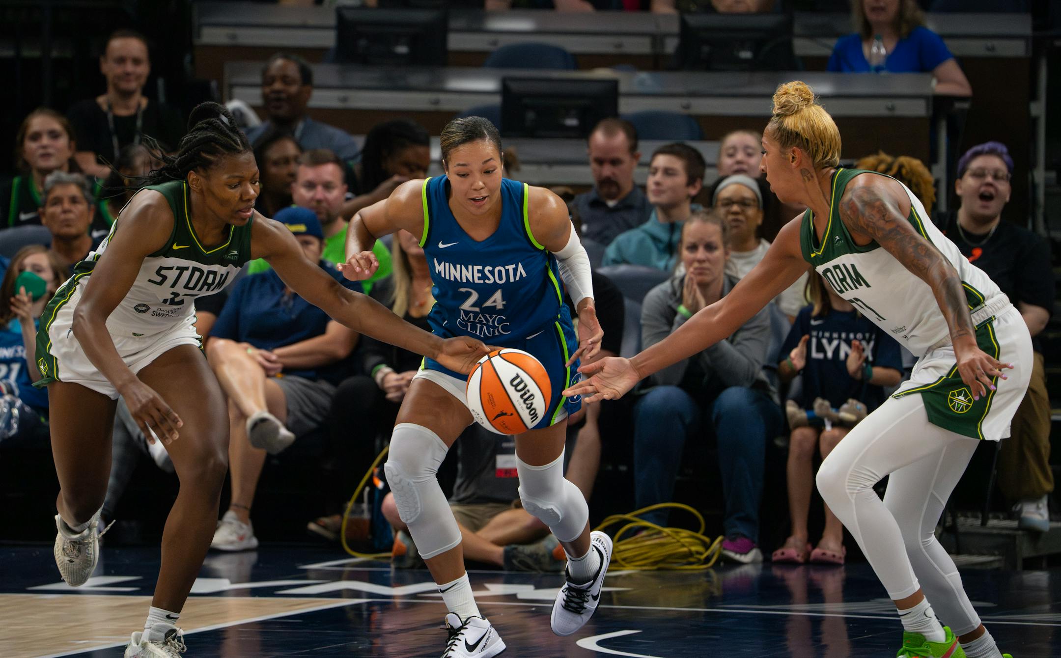 Minnesota Lynx forward Napheesa Collier had the ball taken away from her in the third quarter by the combined effort of Seattle Storm forward Dulcy Fankam Mendjiadeu, left, and Storm center Mercedes Russell.
